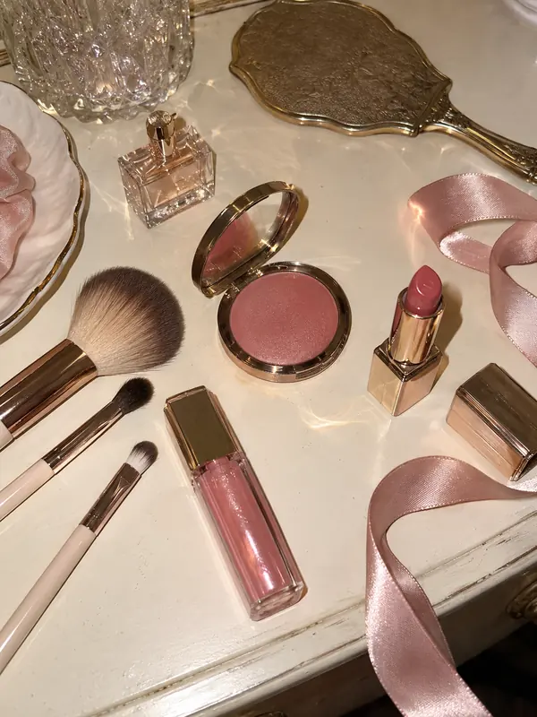 Pink makeup and satin ribbons on a vanity