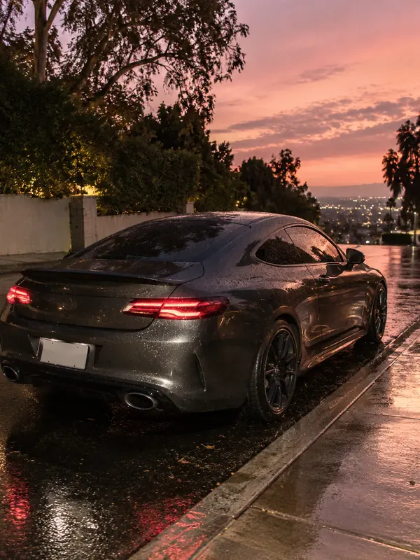 A charcoal sports coupe photographed at dusk