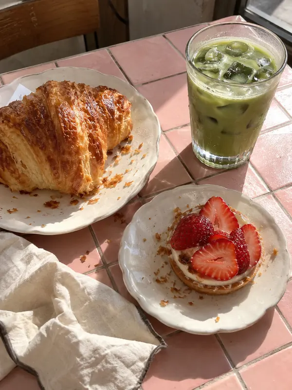 Pastries and iced matcha on a cafe table